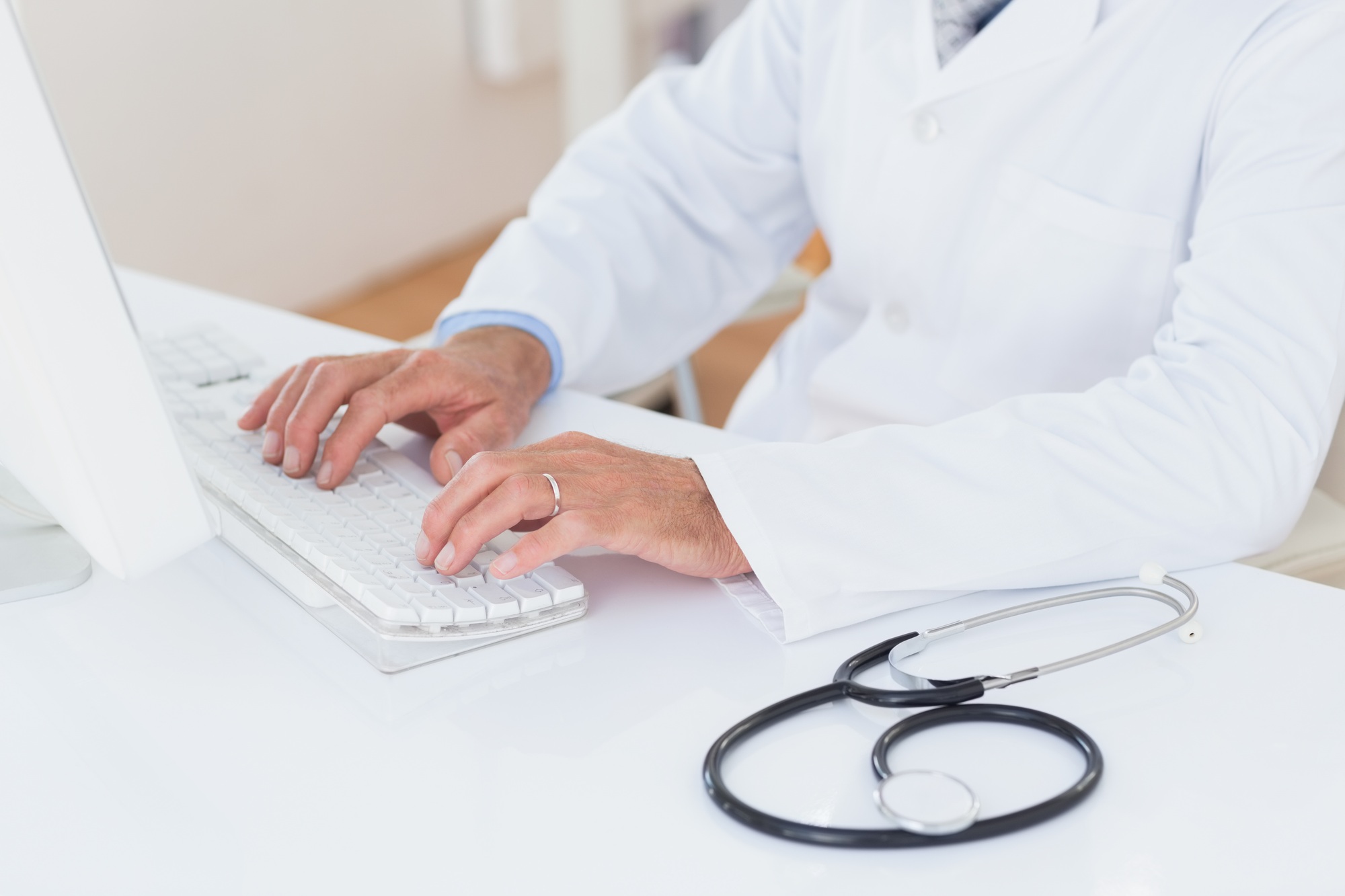 Concentrating doctor using computer in medical office