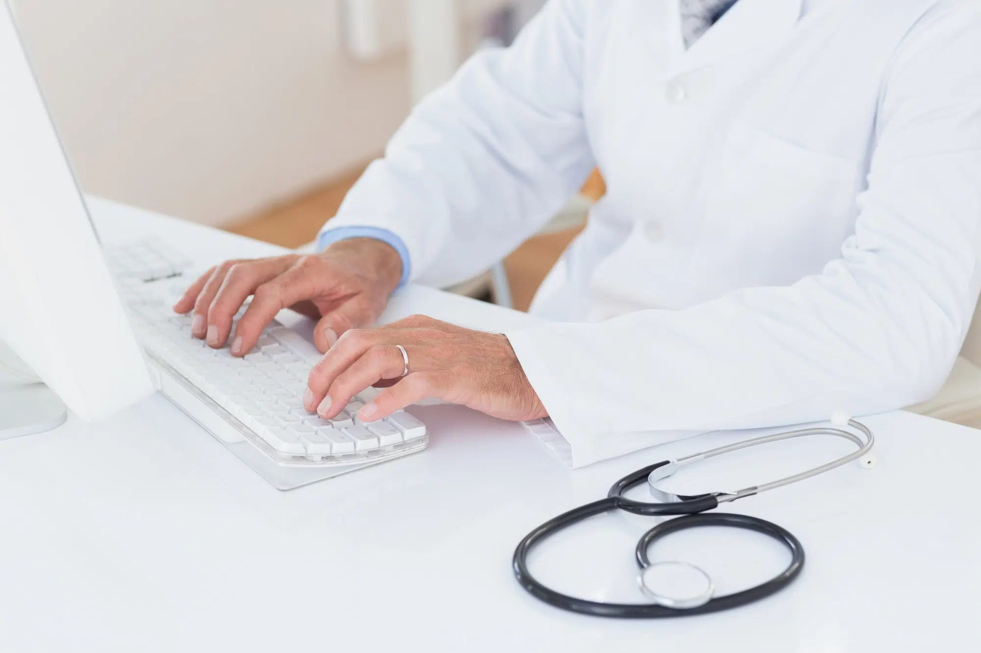 Concentrating doctor using computer in medical office