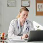 Virtual doctor looking at laptop screen