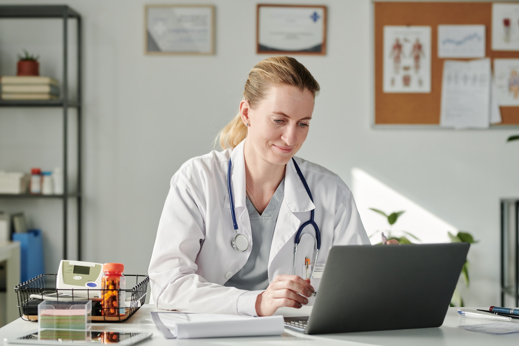 Virtual doctor looking at laptop screen